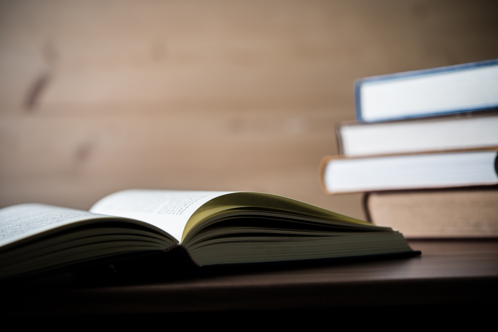 Stack of books on wooden table. Education concept.
